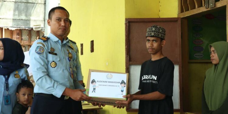 Petugas Rudenim Makassar membagikan sembako ke panti asuhan. (Dok/Rudenim Makassar).